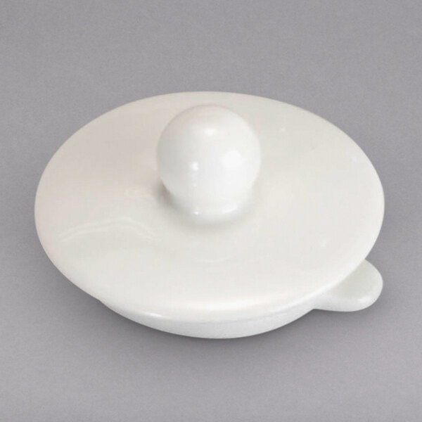 A white round lid for a Villeroy & Boch teapot.