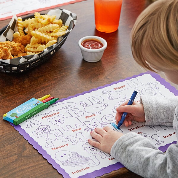 A child coloring on a Hoffmaster Kids Color Me Design Placemat with a blue pen.