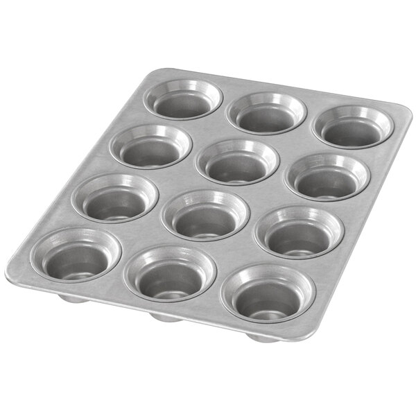 A Chicago Metallic muffin pan with six crown-shaped cups.