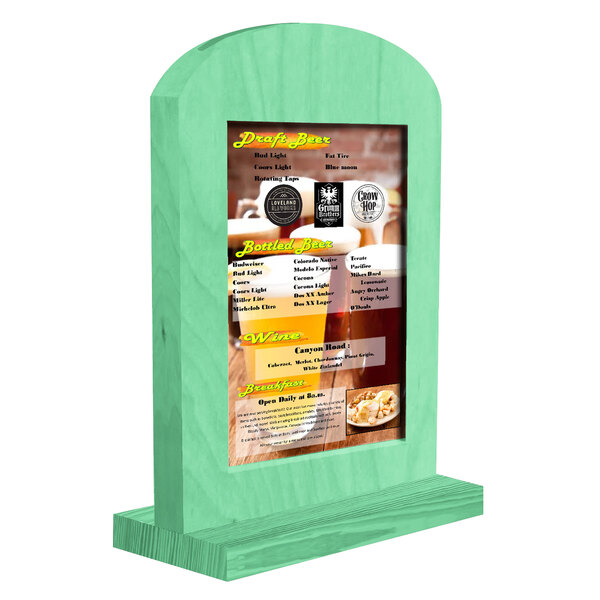 A Menu Solutions washed teal arched wood table tent with a menu on a table