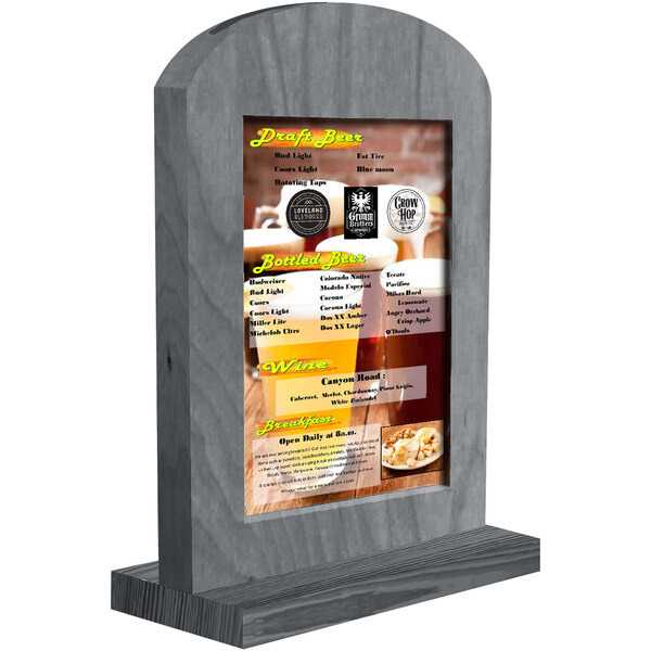 A Menu Solutions ash wood arched menu tent on a table with a menu.