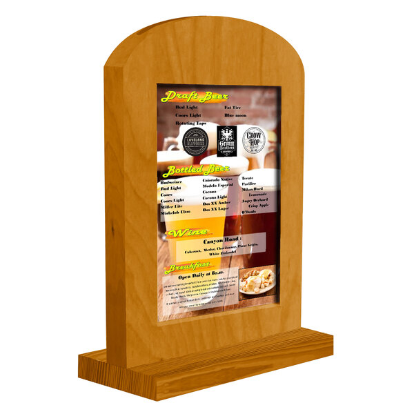 A Menu Solutions Country Oak wooden frame with a menu on a table.