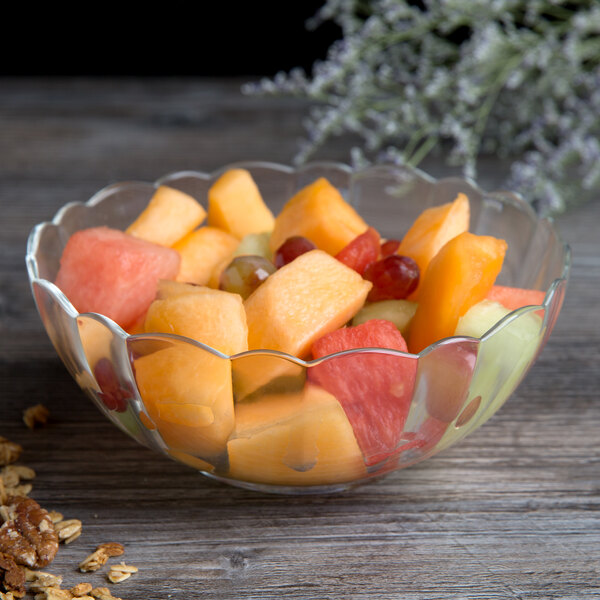 An Arcoroc glass bowl filled with fruit.