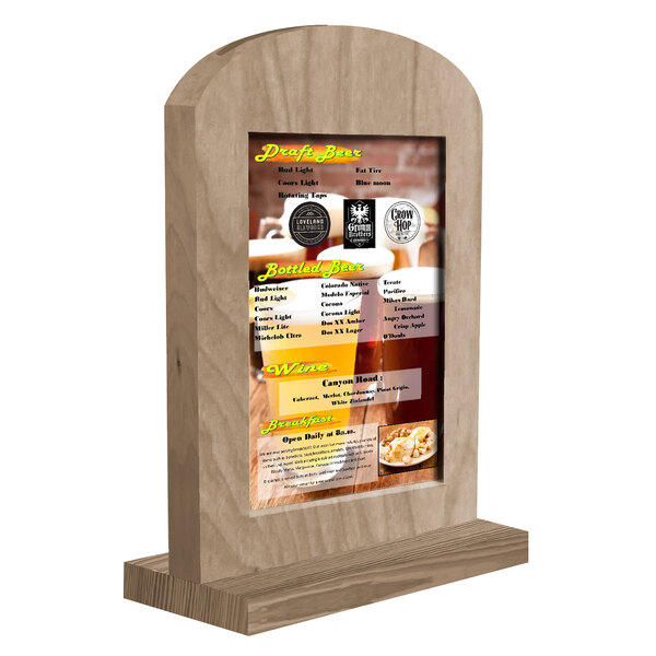 A Menu Solutions weathered walnut wood tent with a menu on a table.