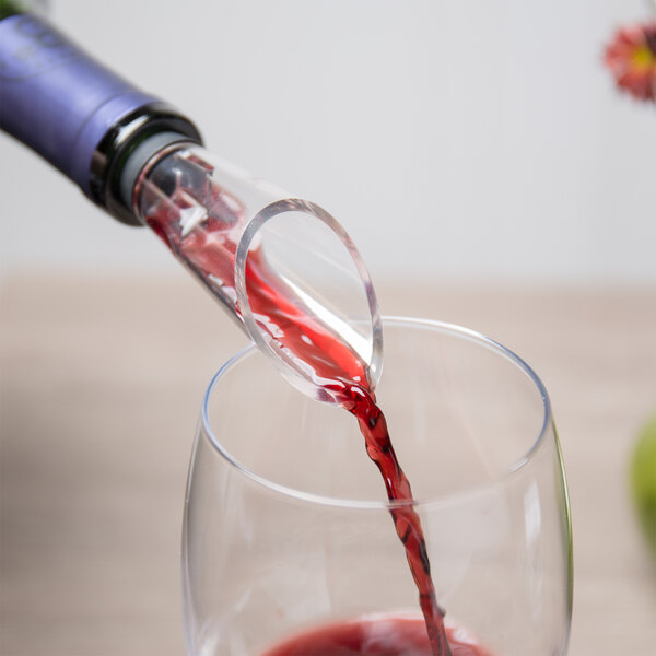 A Franmara wine pourer aerating red wine being poured into a glass.