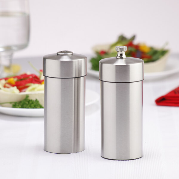 A Chef Specialties stainless steel salt shaker and pepper mill set on a table.