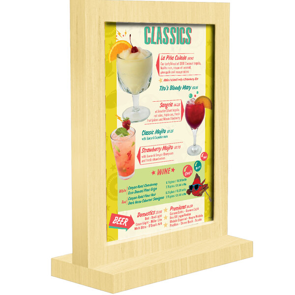 A Menu Solutions natural wood framed menu tent on a table with drinks.