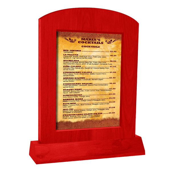 A Menu Solutions arched wood menu tent with an angled base holding a menu on a brown wood table.