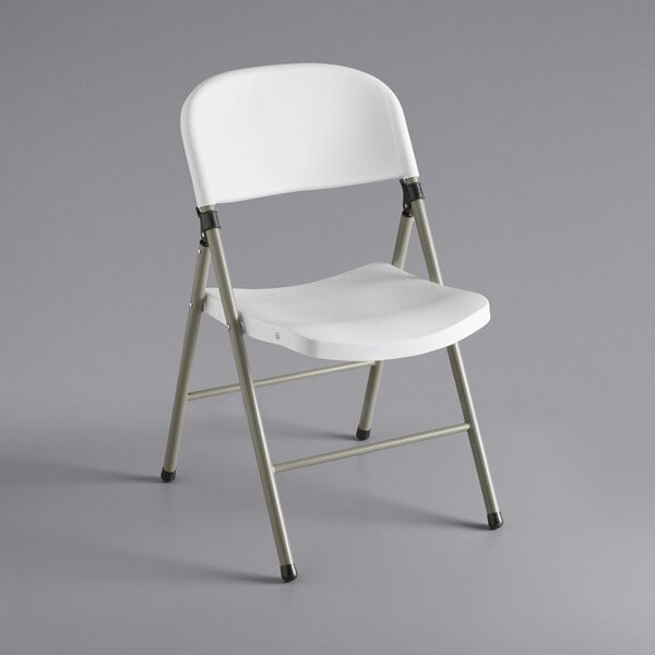 A white folding chair with metal legs.
