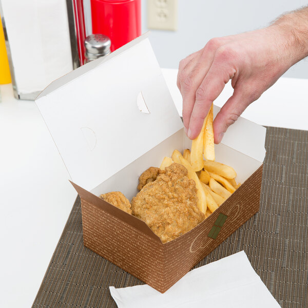 A hand taking a piece of fried chicken out of a red Hearthstone take-out box.