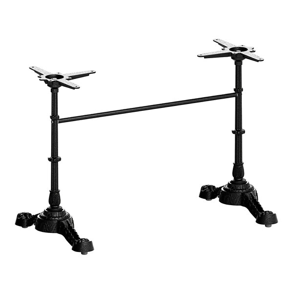 A pair of FLAT Tech black metal table bases on a table.