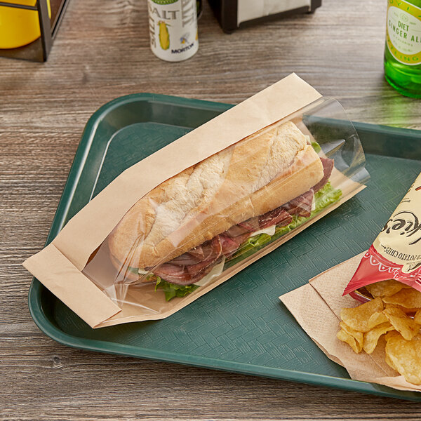 A sandwich and chips on a tray with a Bagcraft Packaging Dubl View ToGo! paper bag with a window.