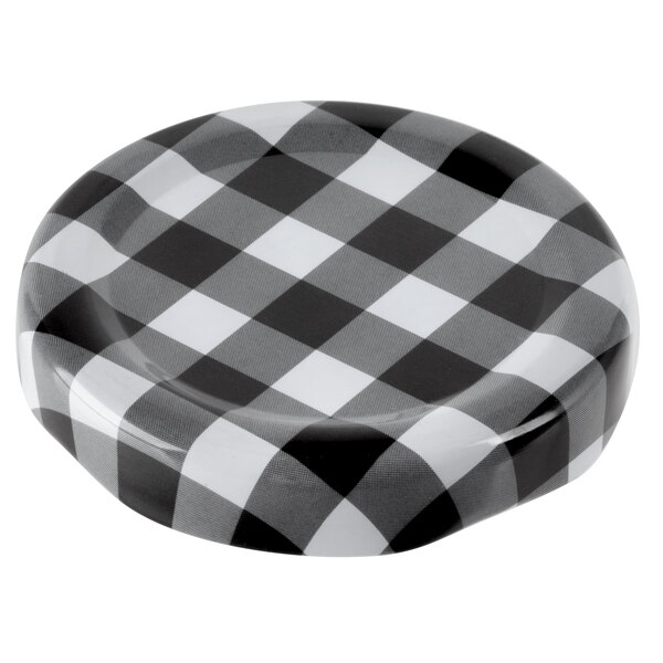 A black and white plaid Acopa milk bottle lid.