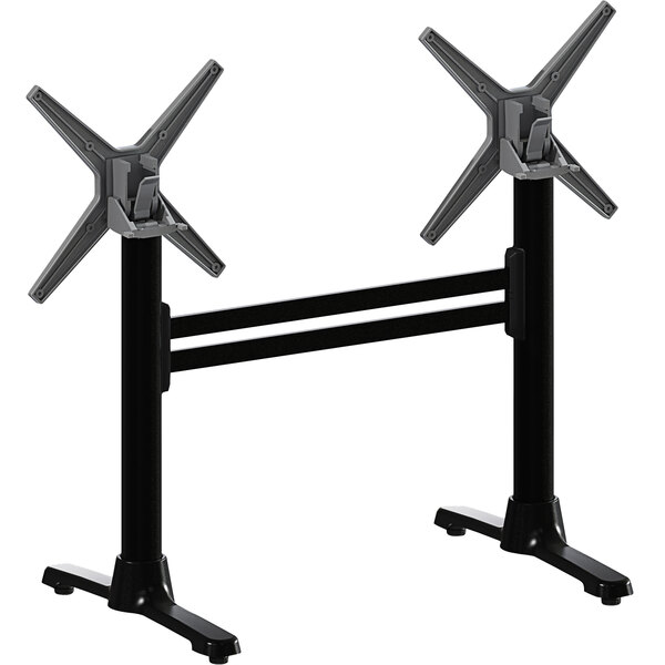 A pair of black metal FLAT Tech table stands with two black and silver X's.