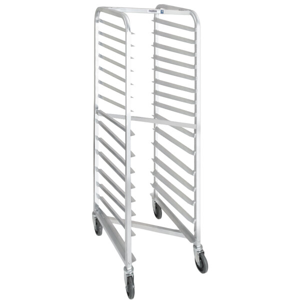 A white heavy-duty metal Channel sheet pan rack with trays on it.
