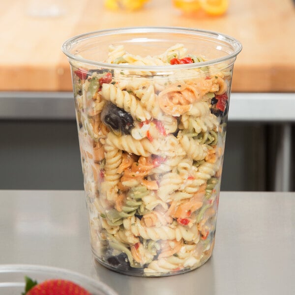 A Fabri-Kal clear plastic deli container with pasta inside.