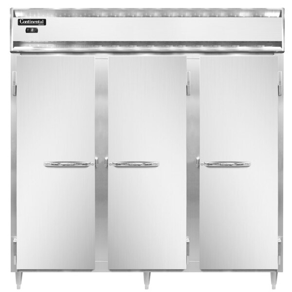 The open doors of three white Continental reach-in freezers.