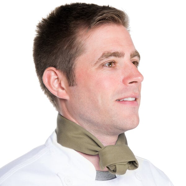 A man in a chef's uniform wearing a beige chef neckerchief.