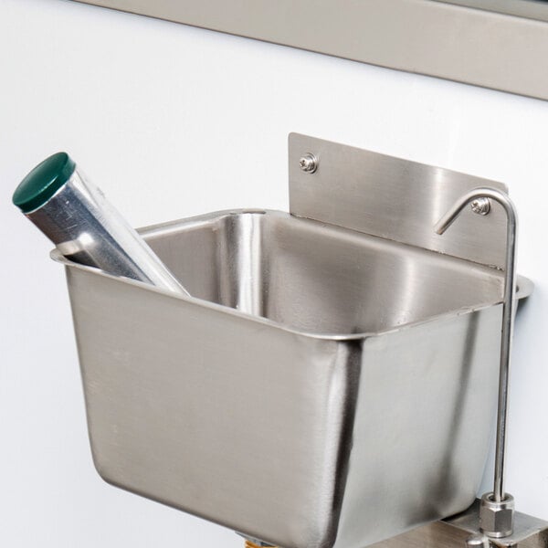 A Regency stainless steel dipper well with a metal bowl and faucet handle.