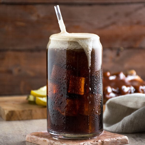 A glass of Narvon Old Fashioned Root Beer with ice and a straw.