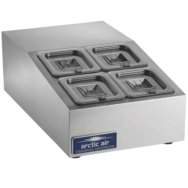 A silver rectangular countertop refrigerated prep rail with four lids.