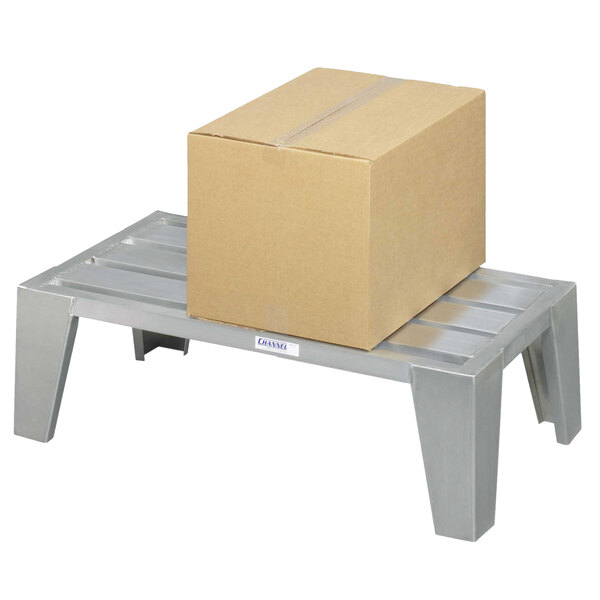 A Channel heavy-duty aluminum dunnage rack with a cardboard box on top.