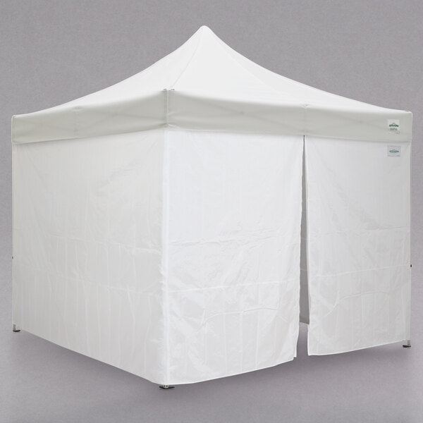 A white Caravan Canopy instant tent with two open doors.