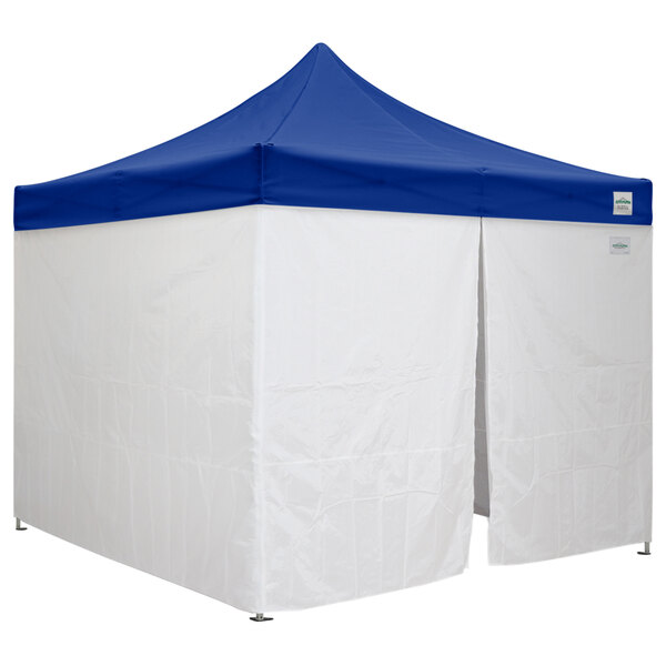 A white and blue Caravan Canopy tent with side walls.
