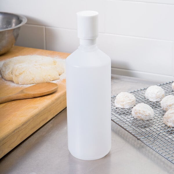 A white plastic Matfer Bourgeat squeeze bottle on a counter.