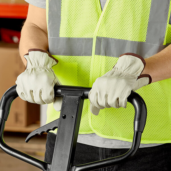 A person wearing Cordova Economy grain pigskin driver's gloves holding a forklift handle.