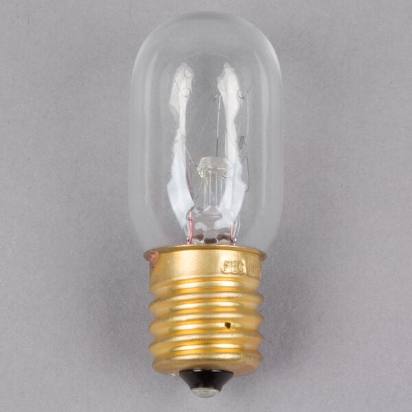 A close-up of a Satco clear incandescent indicator light bulb with a clear cap and gold base.