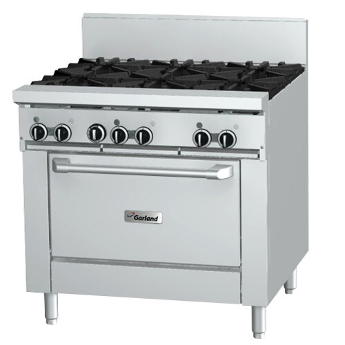 A large stainless steel Garland gas range with six burners and black knobs.