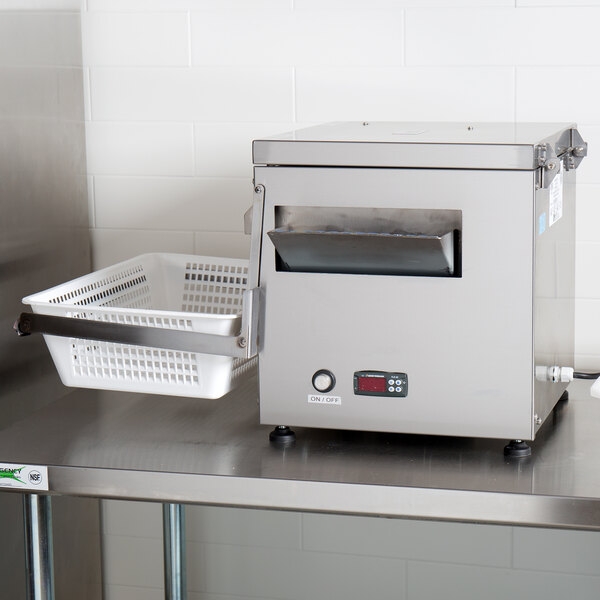 A Campus Products Silvershine countertop cutlery dryer and polisher machine with a white basket and a lid on a table.