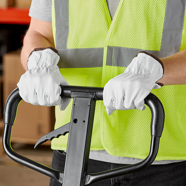 A person wearing Cordova gray leather driver's gloves holding a forklift.