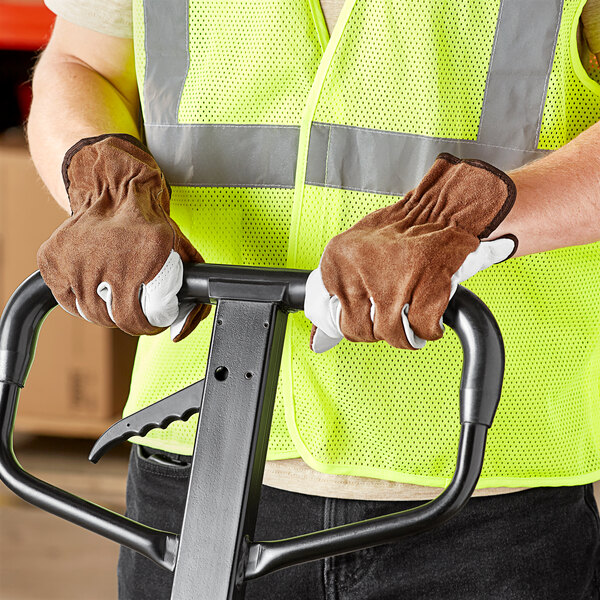 A man wearing Cordova grain cowhide leather driver's gloves holding a forklift handle.