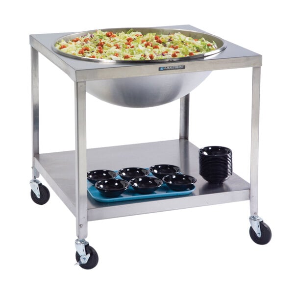 A Lakeside stainless steel mobile mixing bowl stand with a large bowl of food on a cart.