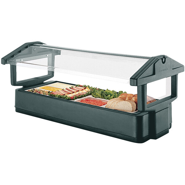 A green Cambro table top food and salad bar with a sneeze guard over food on a counter.