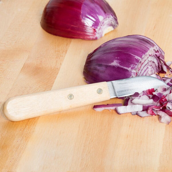 Town 47402 Onion Knife next to a sliced onion on a cutting board.