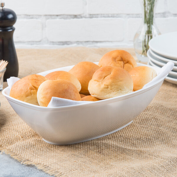 A bowl of bread rolls in a Fineline white plastic bowl.