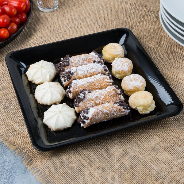 A Fineline black plastic square catering tray with pastries and cookies on it.