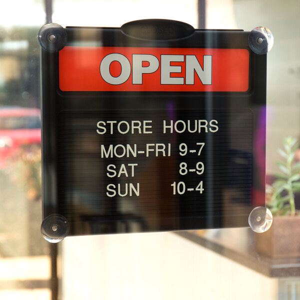 A Headline Sign with red and white text that says "Open" and "Closed" on a window.