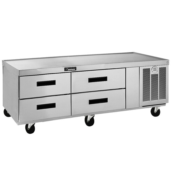 A Delfield stainless steel low profile chef base with four drawers.