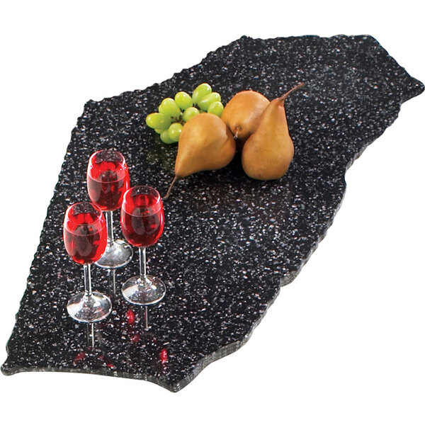 A Cal-Mil simulated black granite tray with pears and grapes on a black surface.
