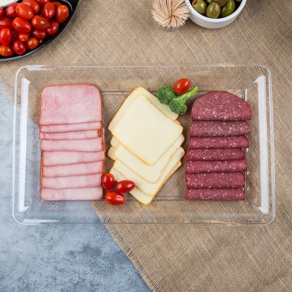 A Fineline clear plastic rectangular catering tray with sliced ham and cheese.