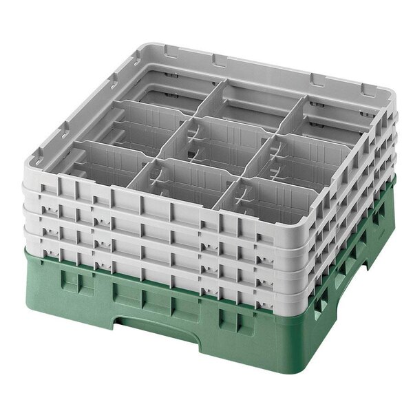 A white and green plastic Cambro glass rack with compartments.