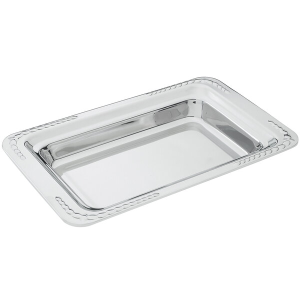 A Vollrath Miramar 3/4 size decorative food pan in silver on a counter.