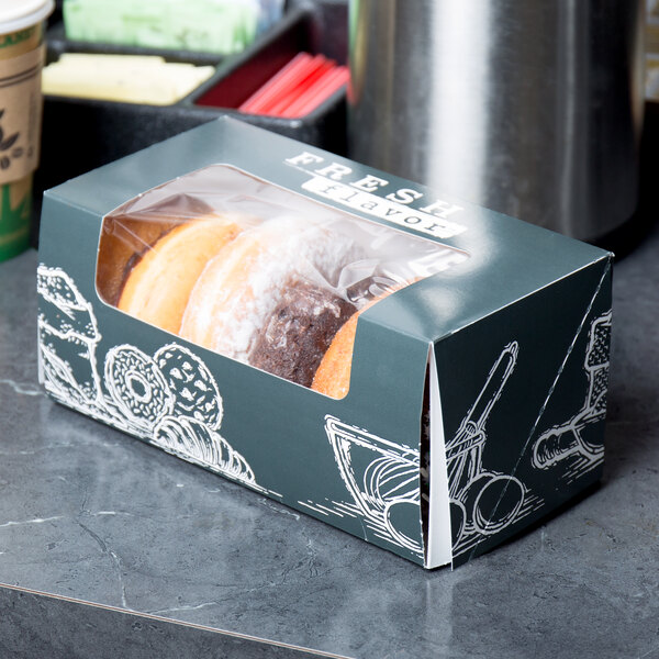 A box of donuts with a Fresh print design on a bakery counter.