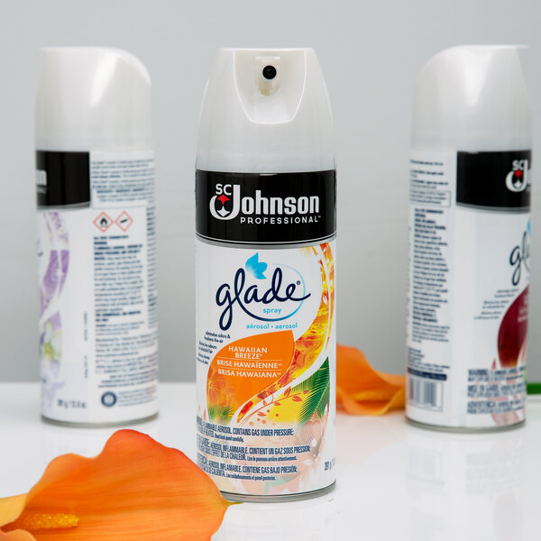 A close-up of a white SC Johnson Glade air freshener can with an orange cap.