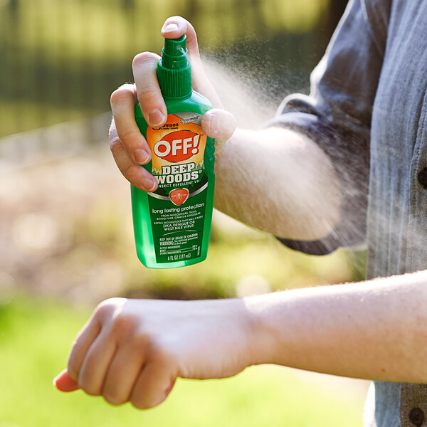 A person spraying SC Johnson OFF! Insect Repellent on their hand.