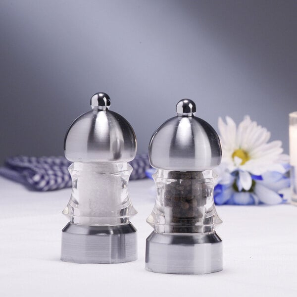 A Chef Specialties Metro pepper mill and salt mill set on a table.